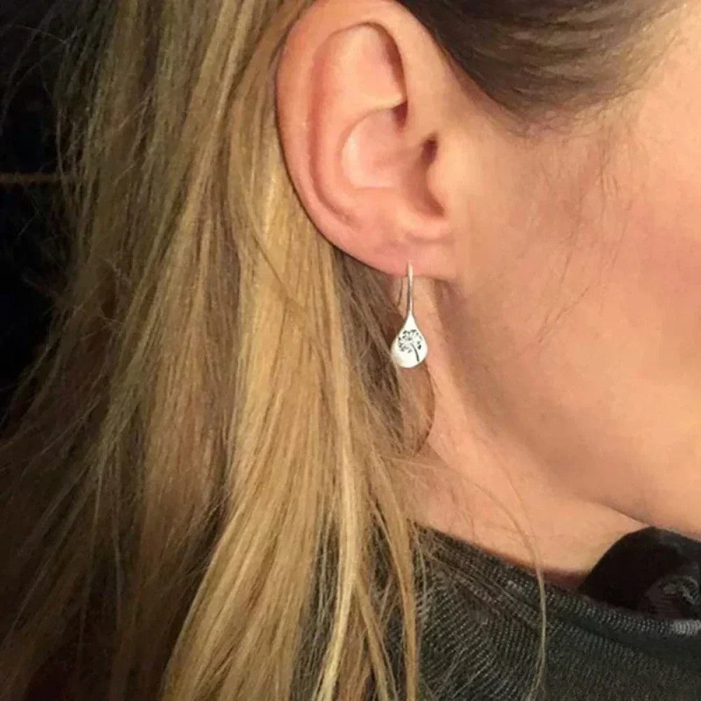 Elegant silver earrings in dandelion leaf design